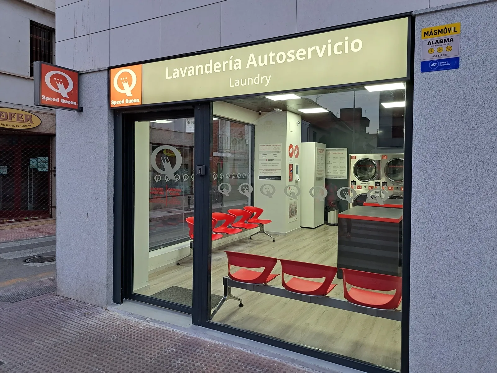 Front of a Gira Gira self-service laundromat open to the public