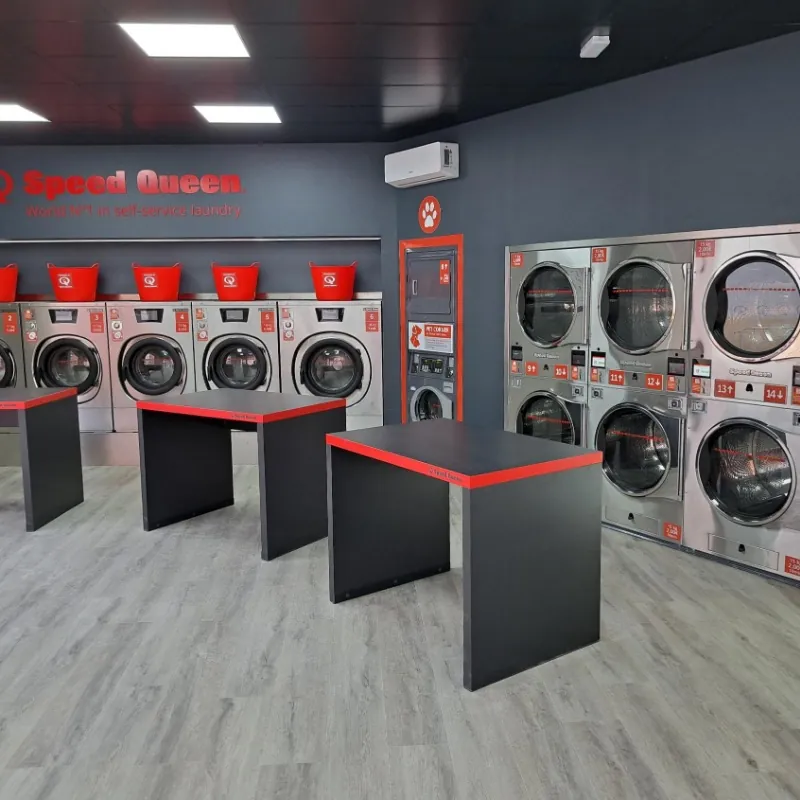 Row of Speed Queen washers and dryers in a Gira Gira laundromat